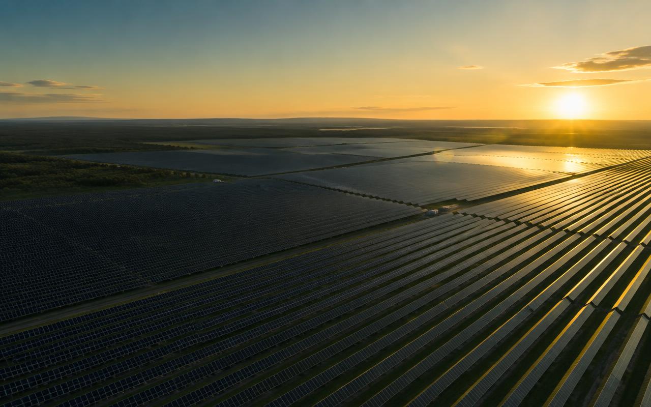 Large solar power plant at sunset